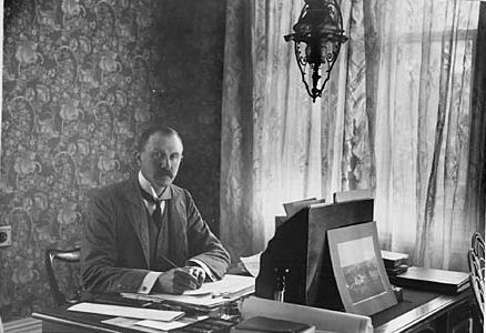 Lord Ranfurly writing at his desk