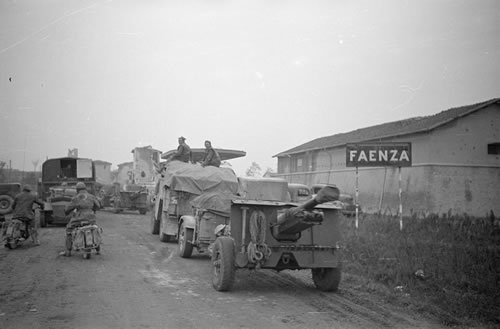 Artillery and motorbikes on dirt road