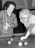 Two women mps playing pool