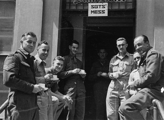 Soldiers enjoying a cup of tea outside a sergeants' mess