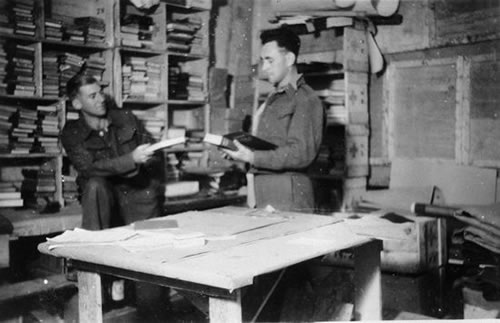 Two men reading in library