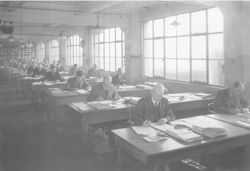 Rows of men working at desks