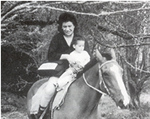 Woman and child on horseback