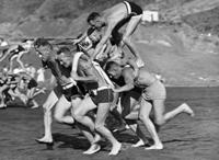 Human chariot racing on beach