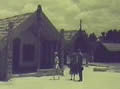 Queen and Guide outside Maori house (whare)