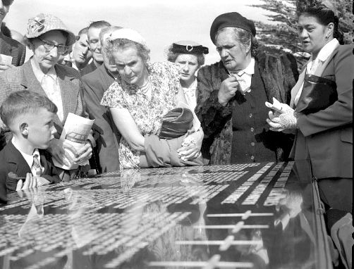 women looking at plaque