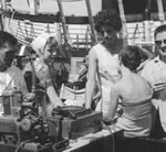 Immigrants playing music  on board ship