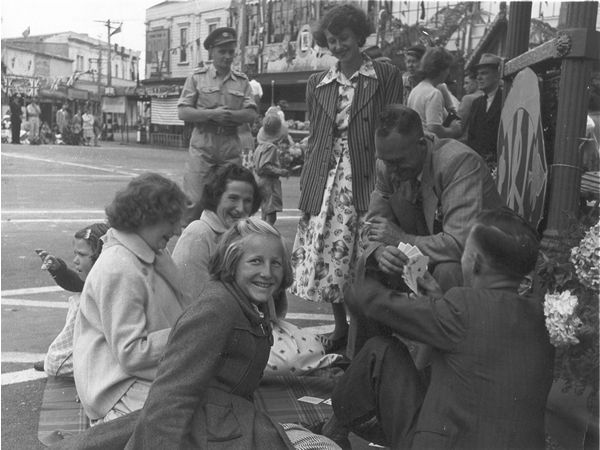 family playing cards on street