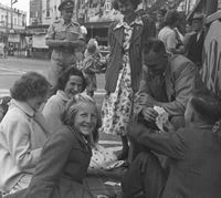 family playing cards on street