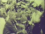 Queen talking to man in wheelchair