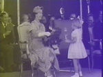 Queen accepting wreath from girl