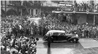 Royals drive down a crowded Queen Street