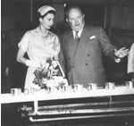 Queen viewing cans on conveyor belt