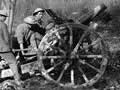 howitzer being fired by group of soldiers